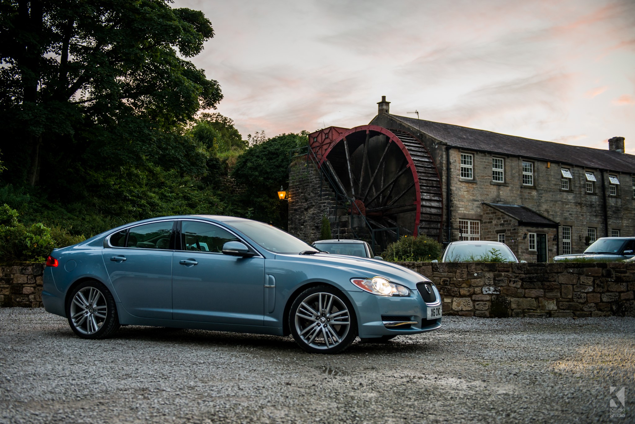 Jaguar XF-S next to a watermill