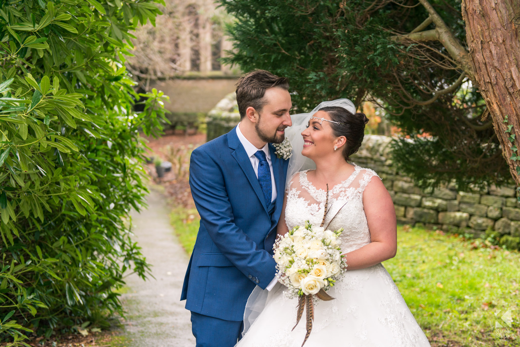 Bride and Groom standing together outside the church