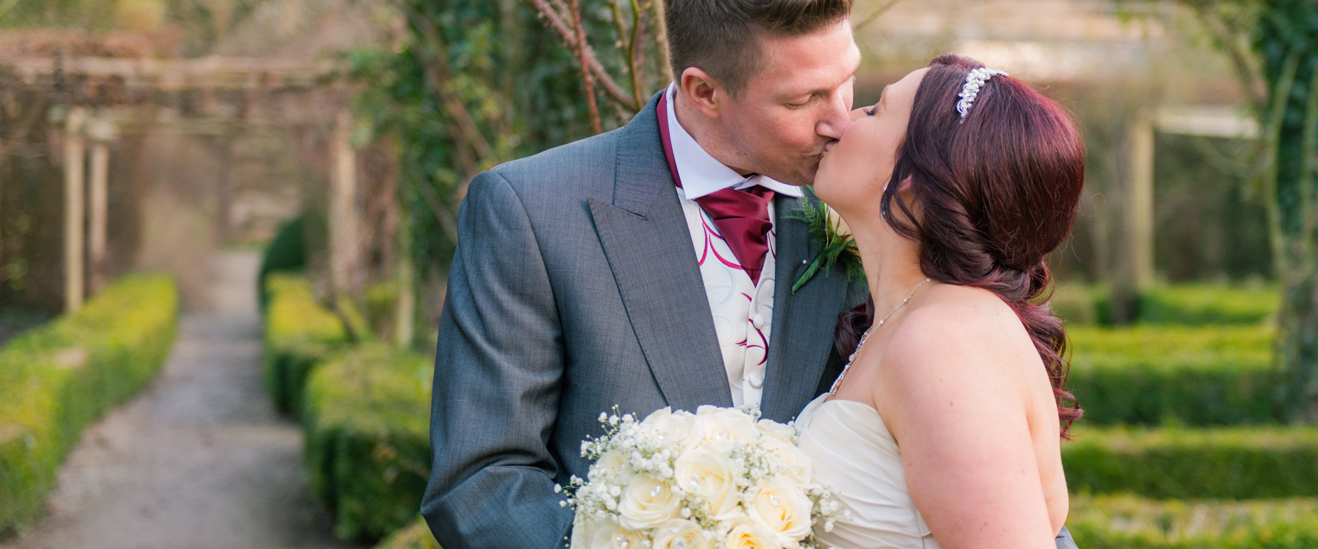 Ripley Castle Wedding - Bride and Groom kissing in the garden