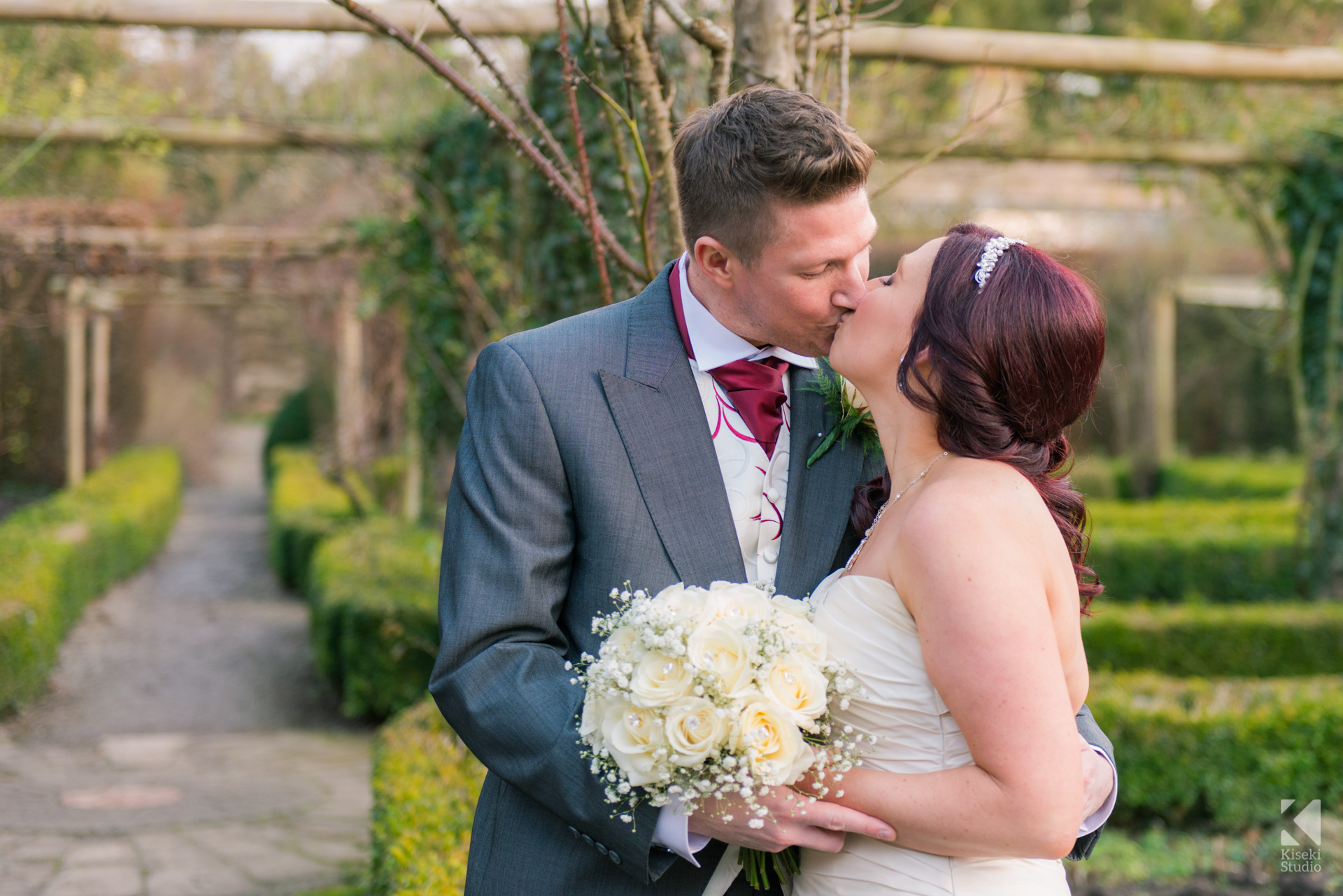 Ripley Castle Wedding - Bride and Groom kissing in the garden